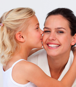 Little girl kissing her mother